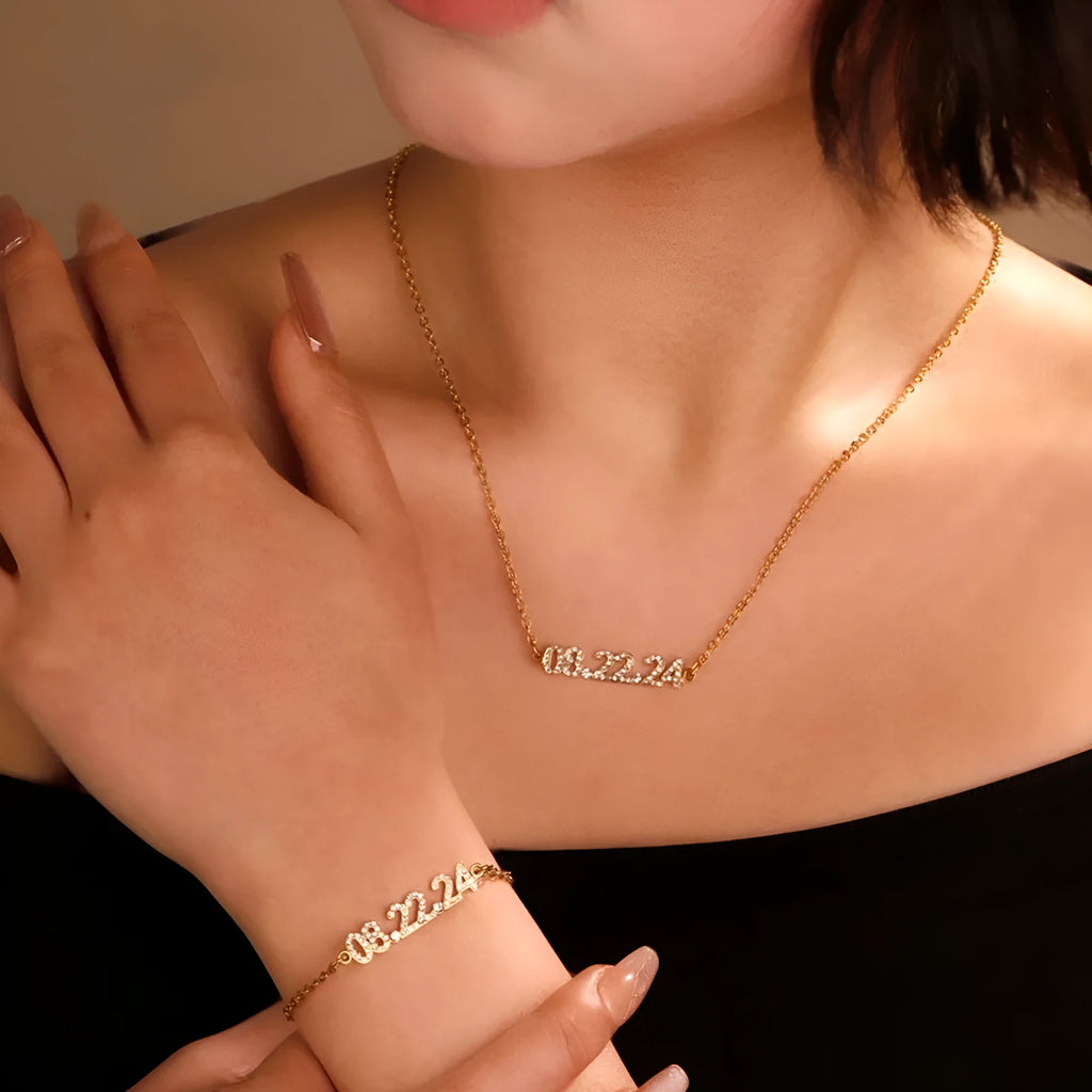 Stainless steel digital bracelet watch with diamond-set numbers on the face, shown in gold tone.