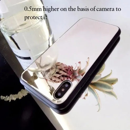 Black mirror phone case for Apple iPhone models X, 7 Plus, and 8 Plus on a table.