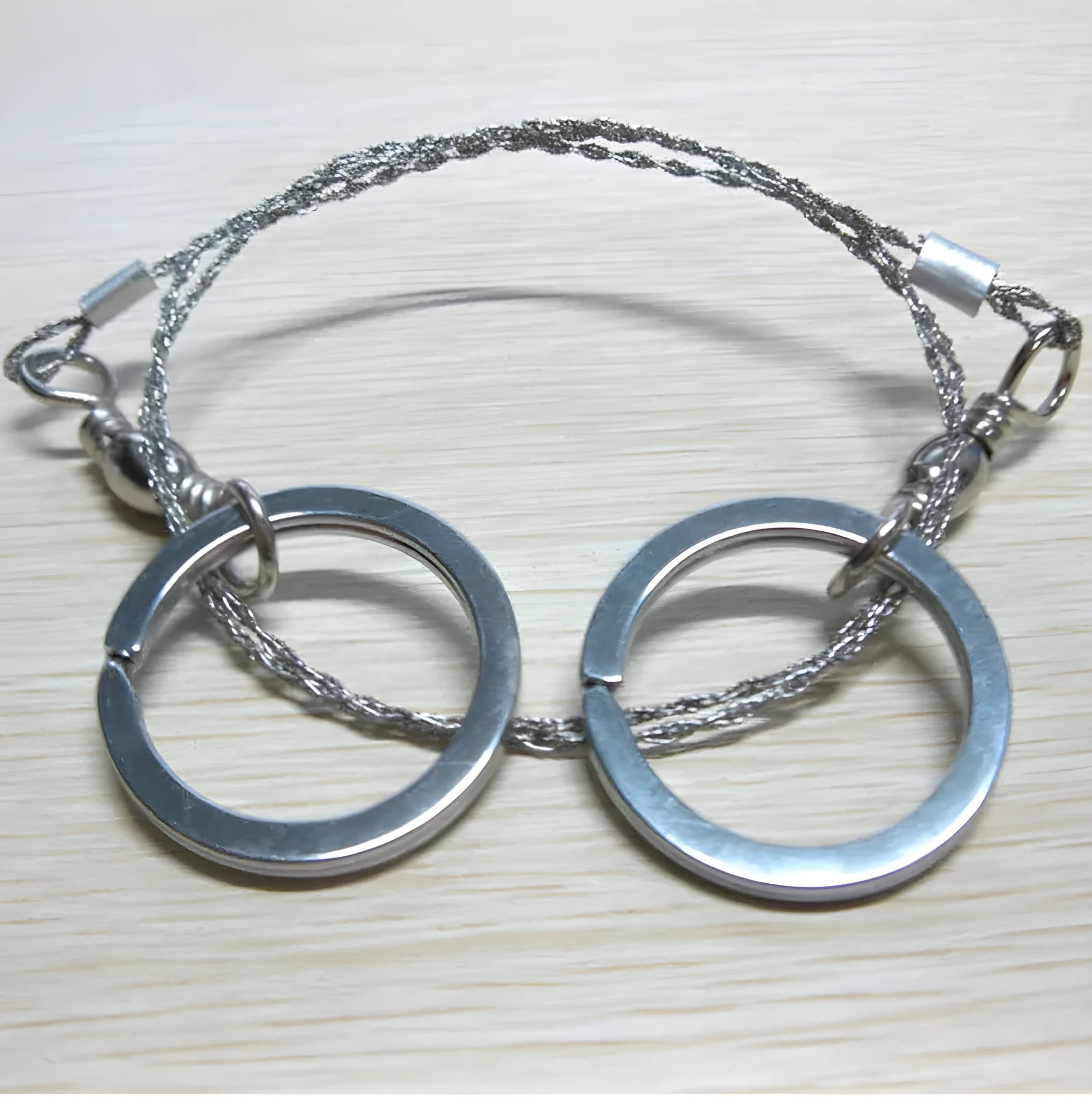 Stainless steel survival wire saw with pull rings showing 55cm cutting blade and extended 70cm total length