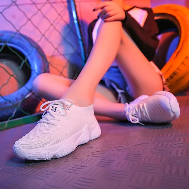 Women's white thick-soled casual shoes with woven upper and front strap.