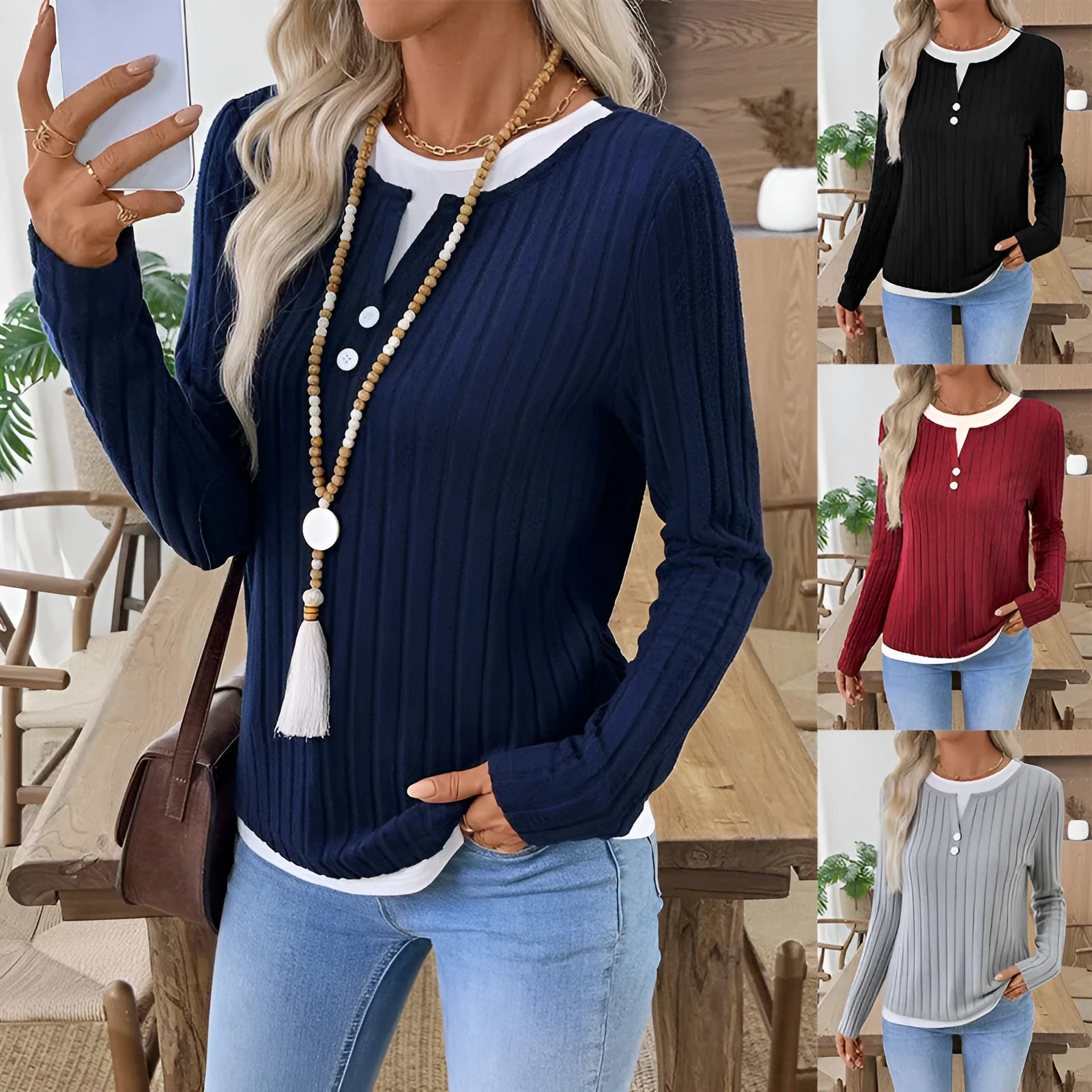 Women's black fake two-piece pullover sweater with round neck, button, and long sleeves on a hanger.
