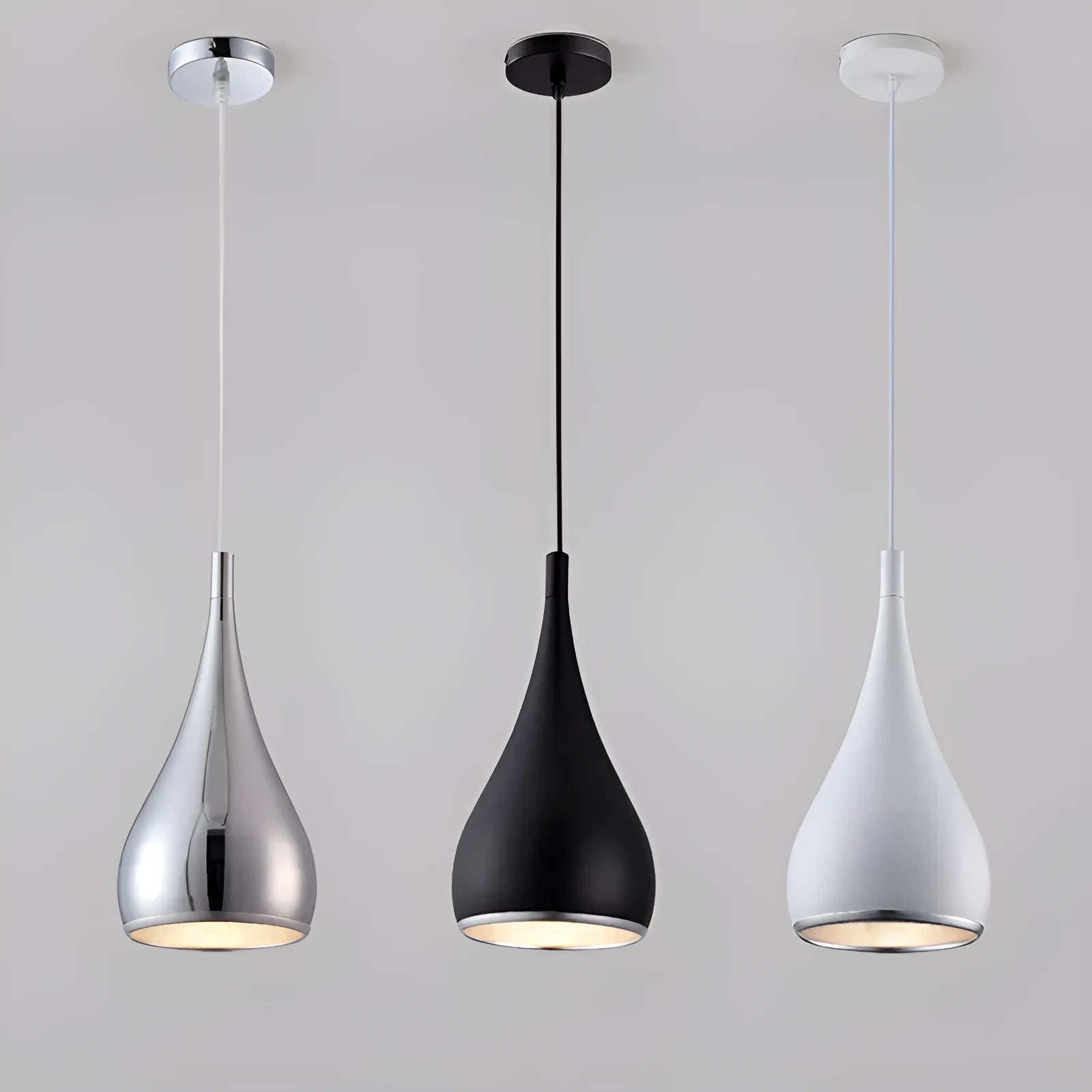 Minimalist iron pendant chandelier with three adjustable heads in a black finish, hung from a ceiling.