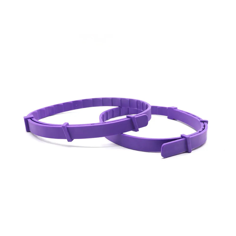 Pack of four monochrome patterned TPR dog anxiety relief collars in assorted colours, laid flat showing 62cm length.