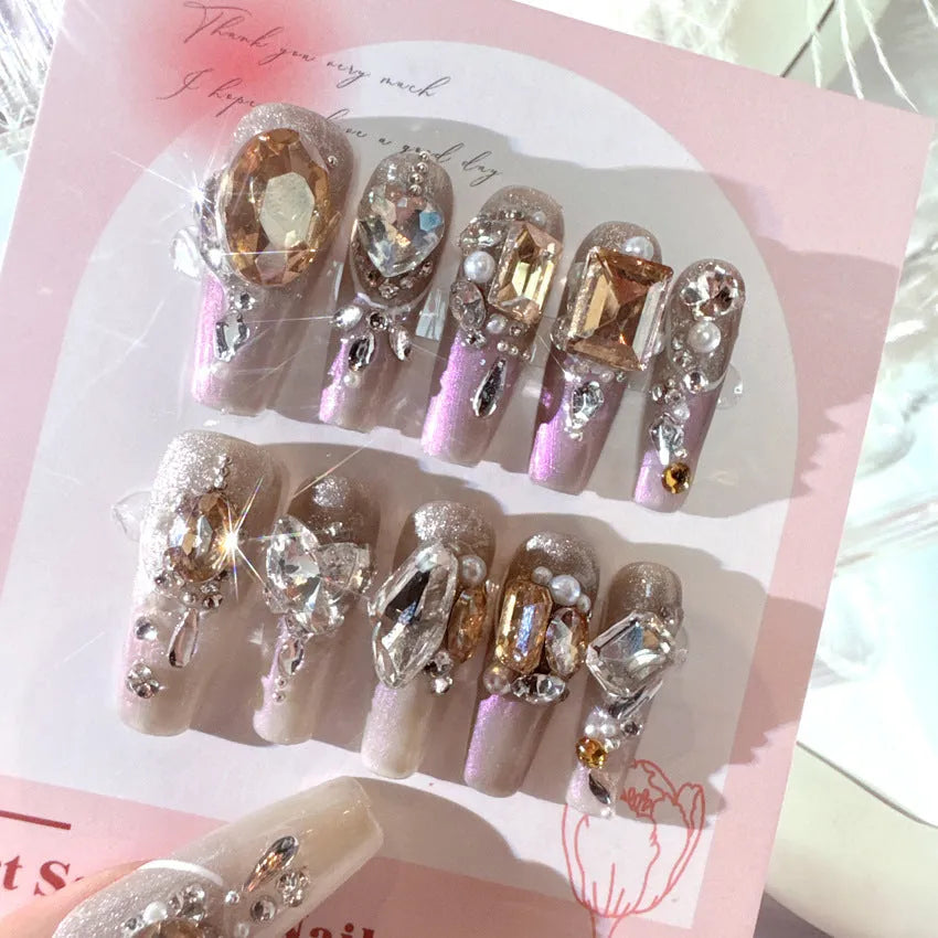 S number size luxury rhinestone false nail patches with jelly adhesive and tool options on card packaging.