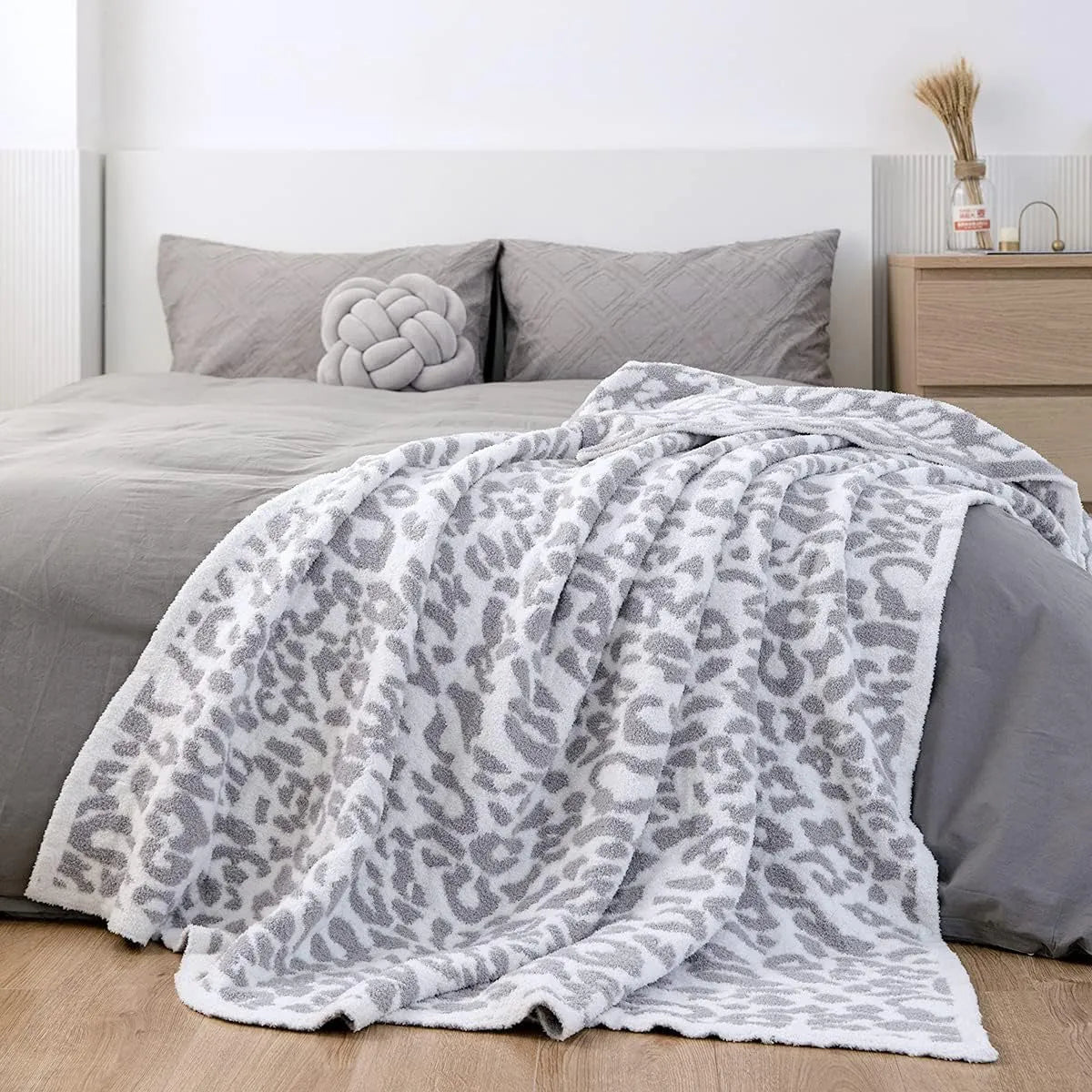 Half velvet leopard print knitted blanket in gray on a sofa, size 130x150cm