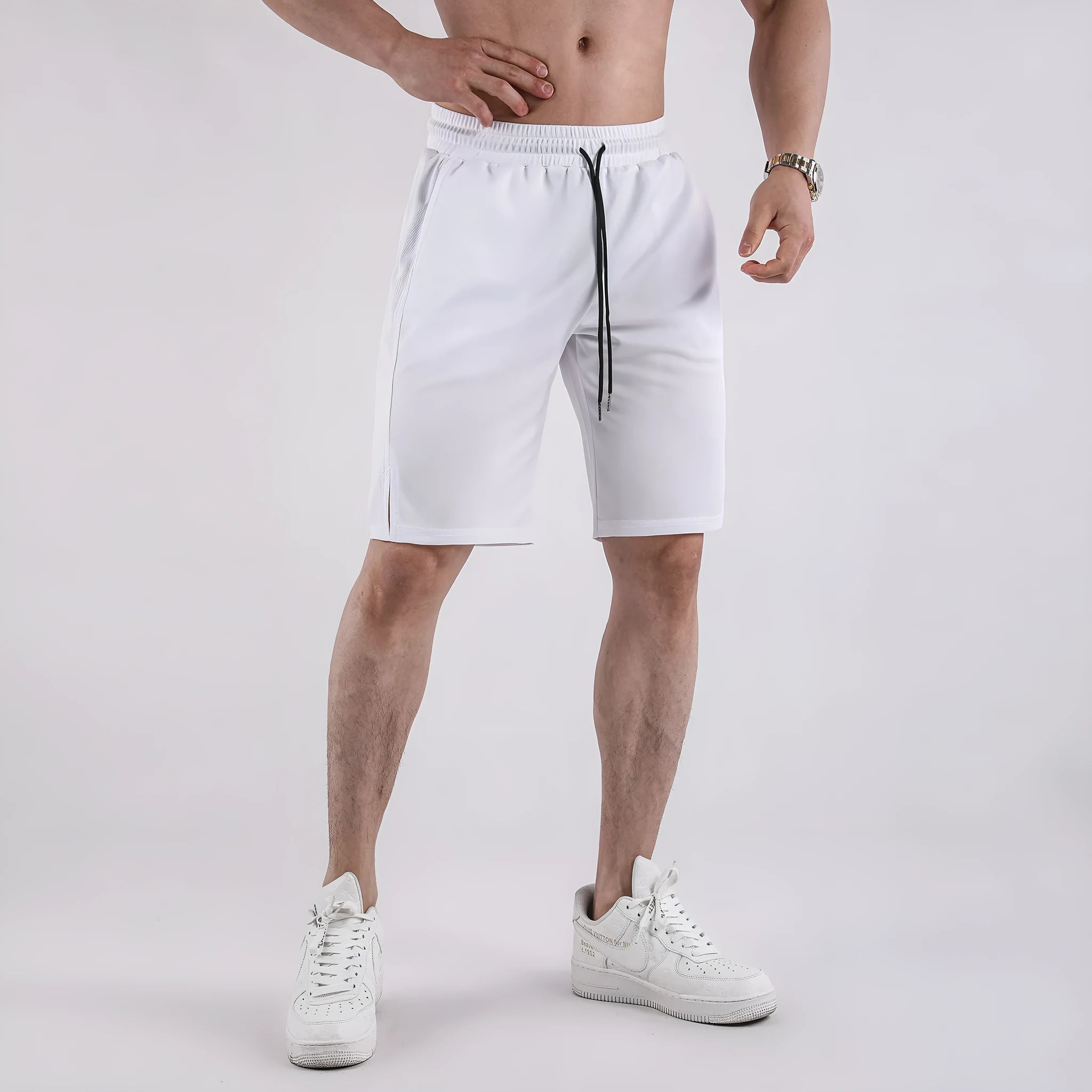 Man wearing loose-fit black quick-dry mesh shorts for casual summer sportswear.