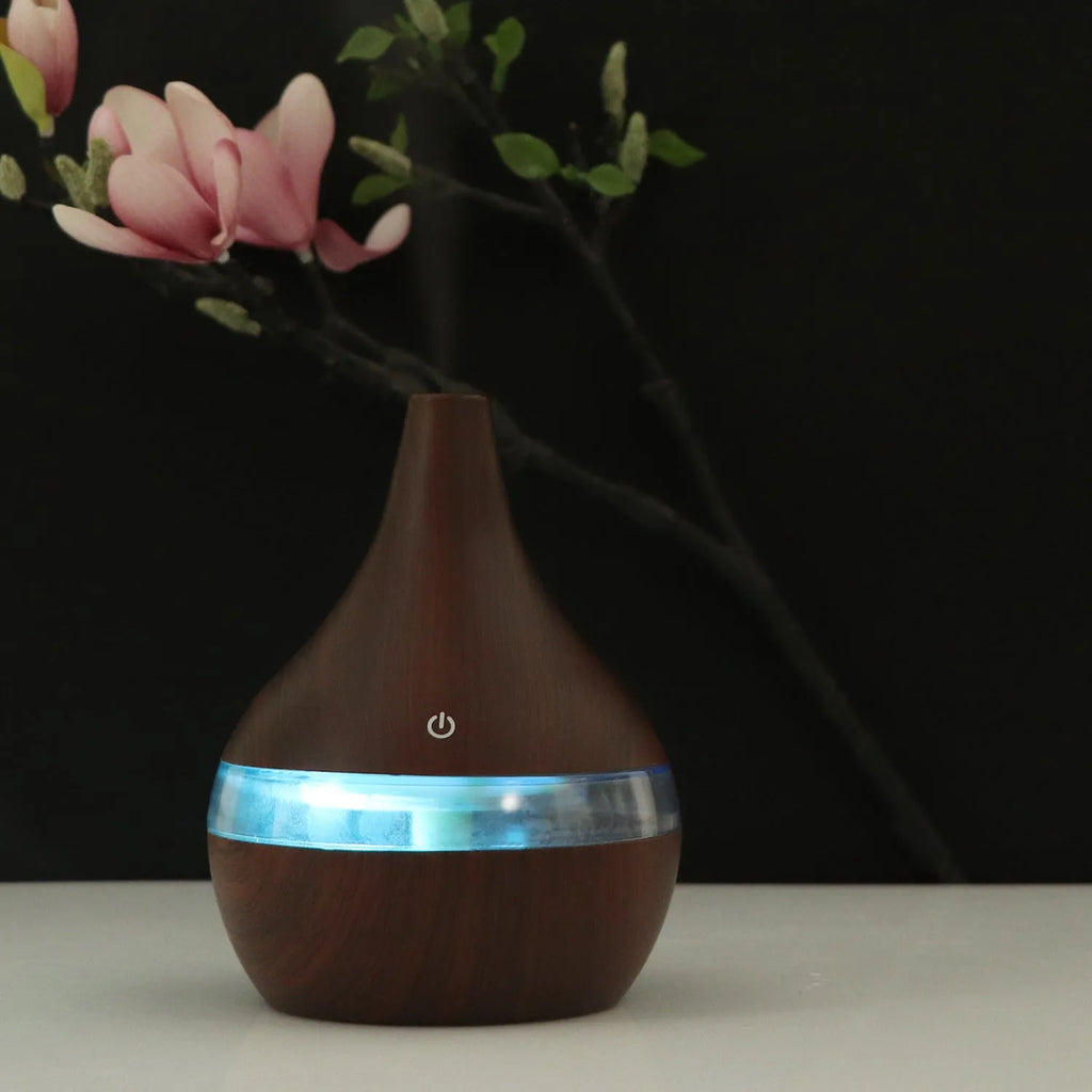 Columnar USB mini air purifier and humidifier in wood grain finish on a desk