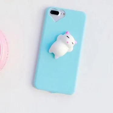 Soft silicone iPhone case with a raised 3D cartoon cat design on the back, shown in pink.