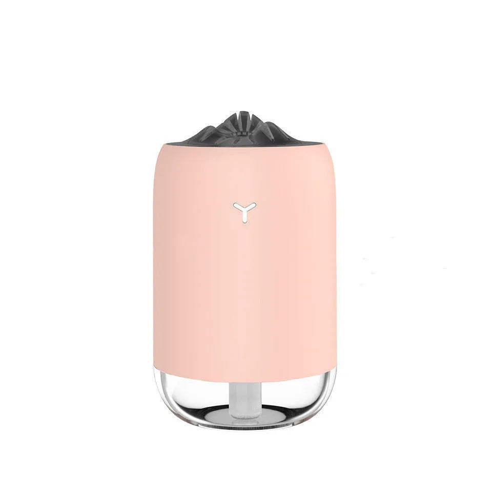 Mini cylindrical USB humidifier with night light in turquoise green, showing water tank and mist outlet