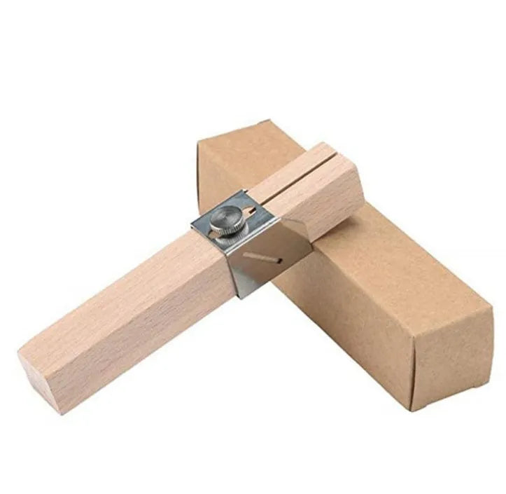 Plastic bottle cutter in log colour, 2.2 by 2.2 by 14 cm, on a table