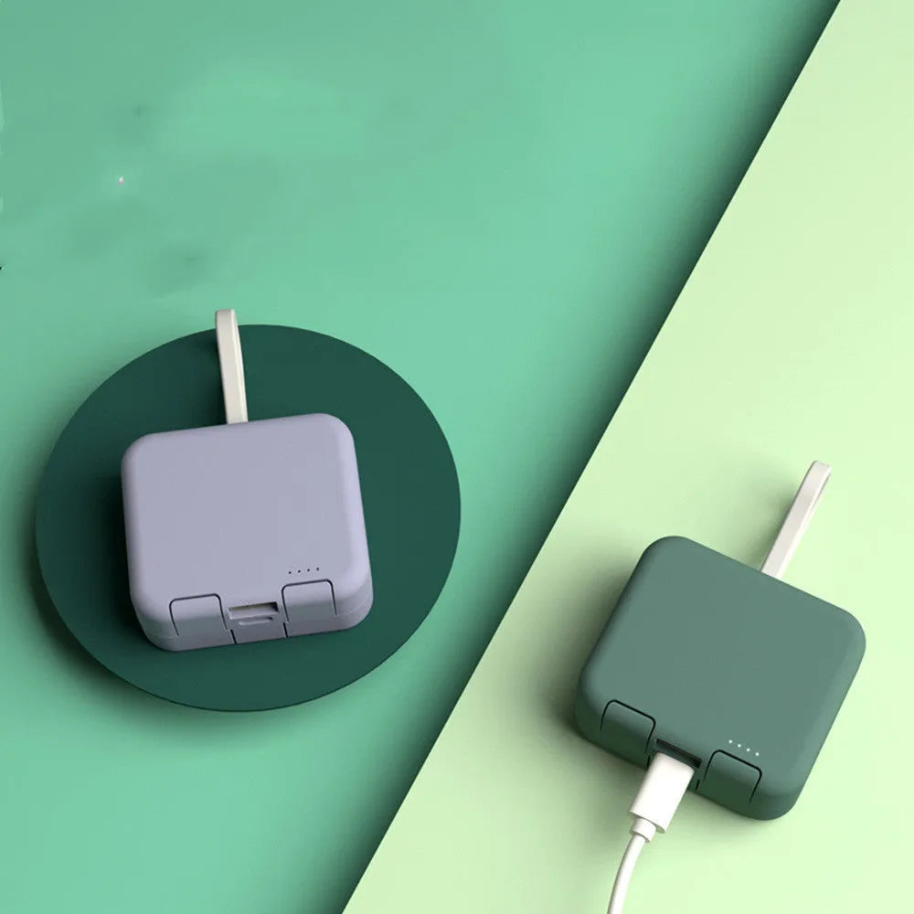Handbag clip power bank in blue, green, red, or white with mobile phone stand functionality and dual charging ports
