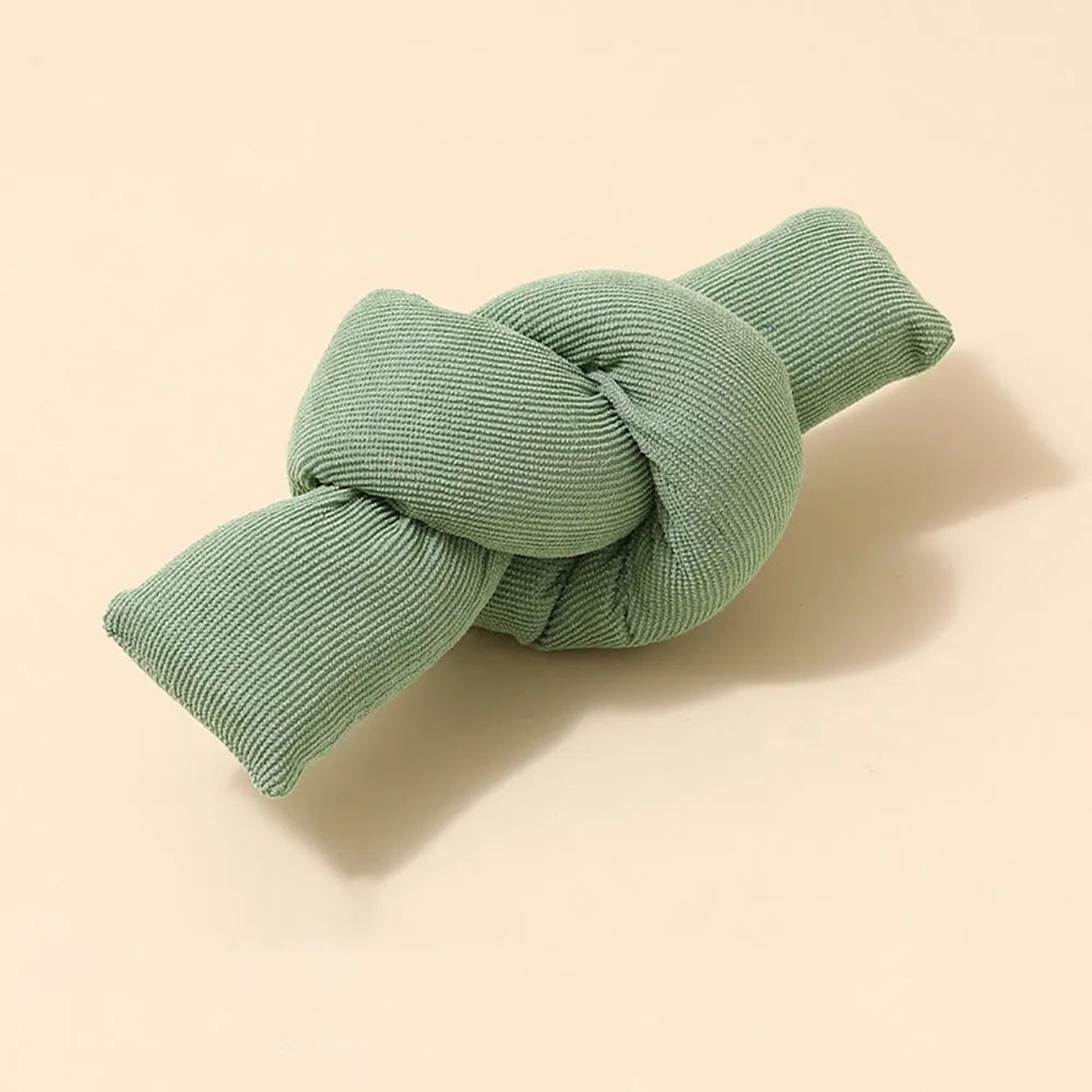 White knotted cotton rope dog toy for chewing and tug of war.