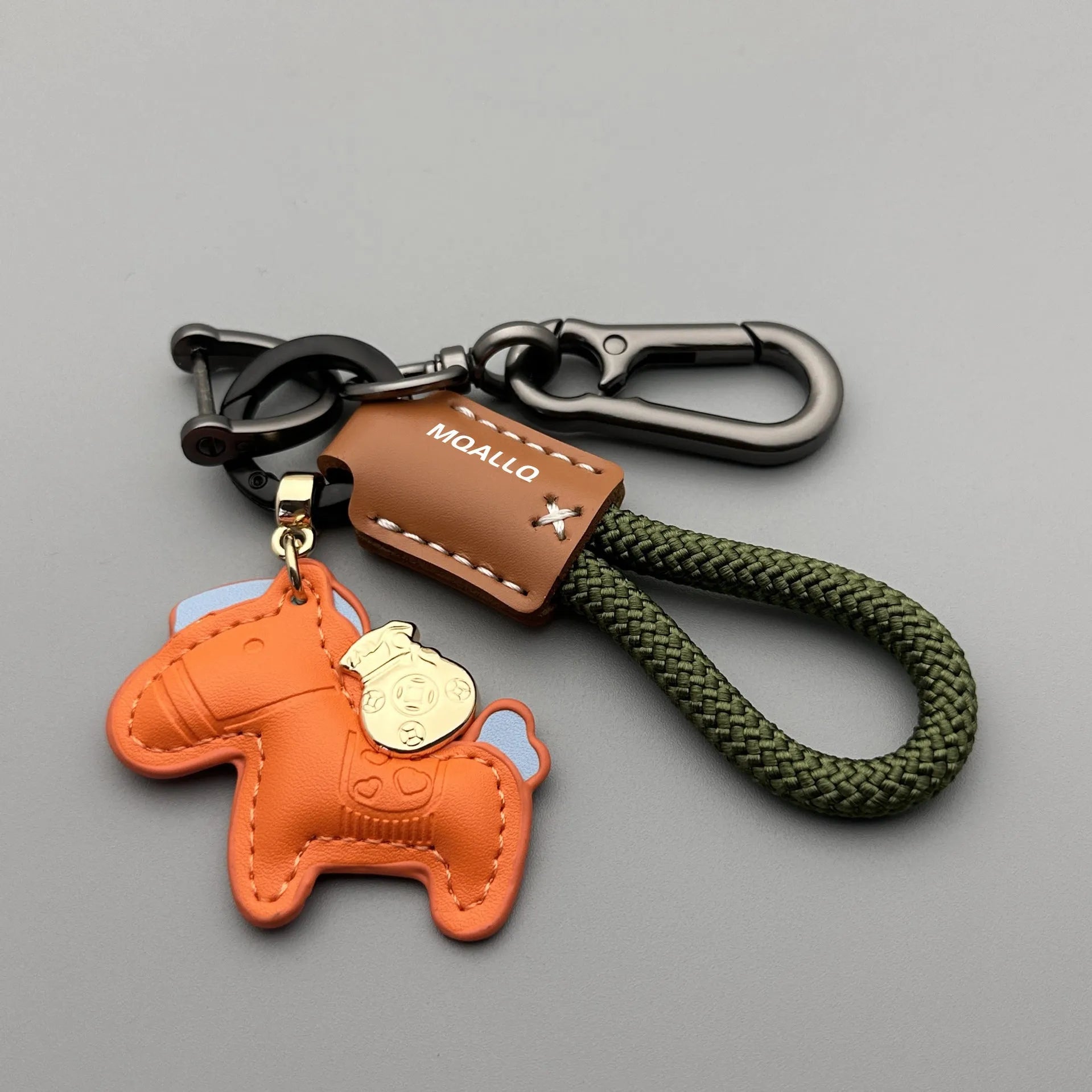 Handmade brown cowhide leather keychain with a silver pony belt buckle charm and green velvet rope.