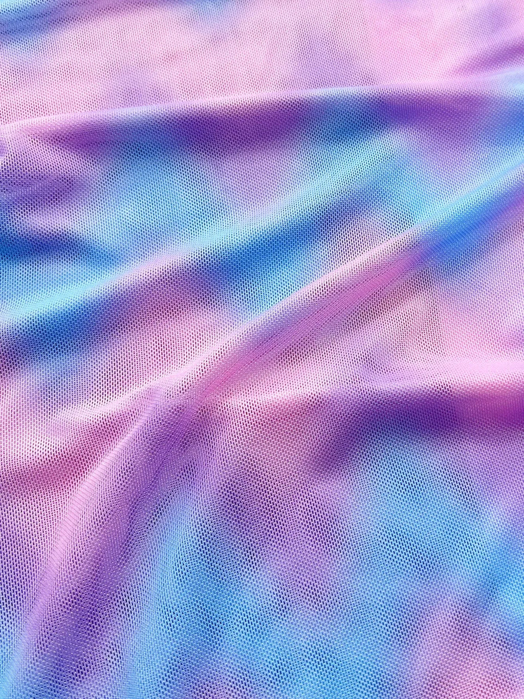 Women's split tie-dye bikini swimsuit set with matching skirt on mannequin