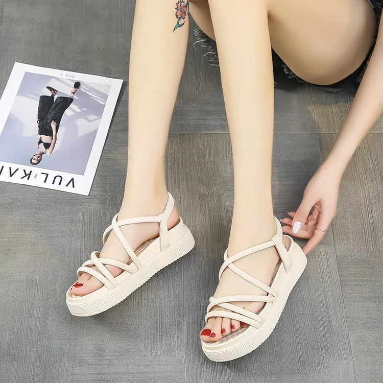 Women's black Roman-style platform sandals with a round toe and slip-on sleeve design.
