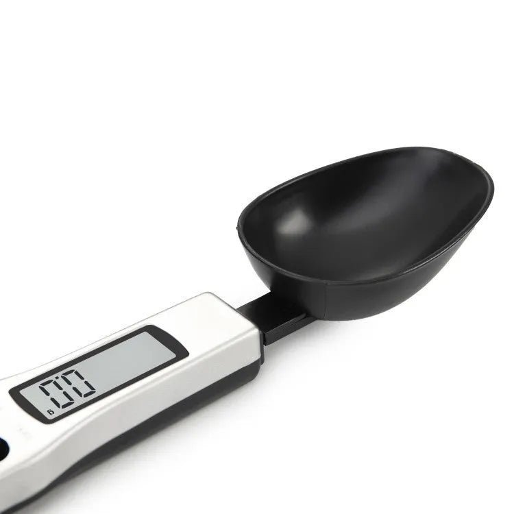 Digital measuring spoon with electronic display showing weight measurement in grams