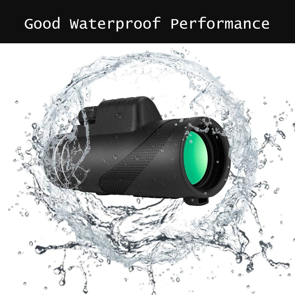 Black 40x60 monocular telescope with mobile phone attachment for photography on a table.