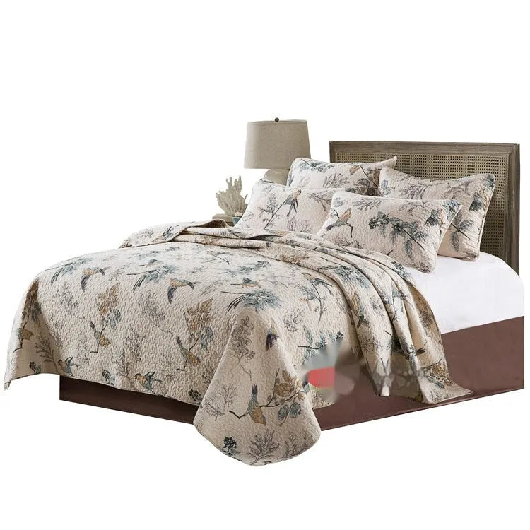 American style pure cotton quilted bedspread with two pillowcases on a double bed.