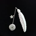 Luminous retro pure copper feather metal bookmark with glow-in-the-dark design showing silver feather and celestial accents