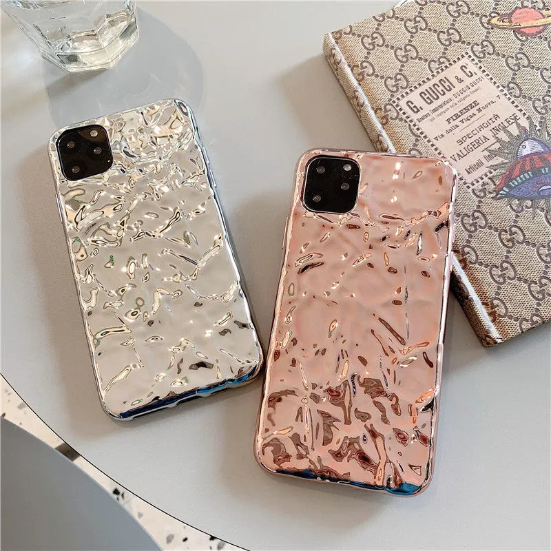 Rose gold folded TPU back cover case for iPhone on a plain background.