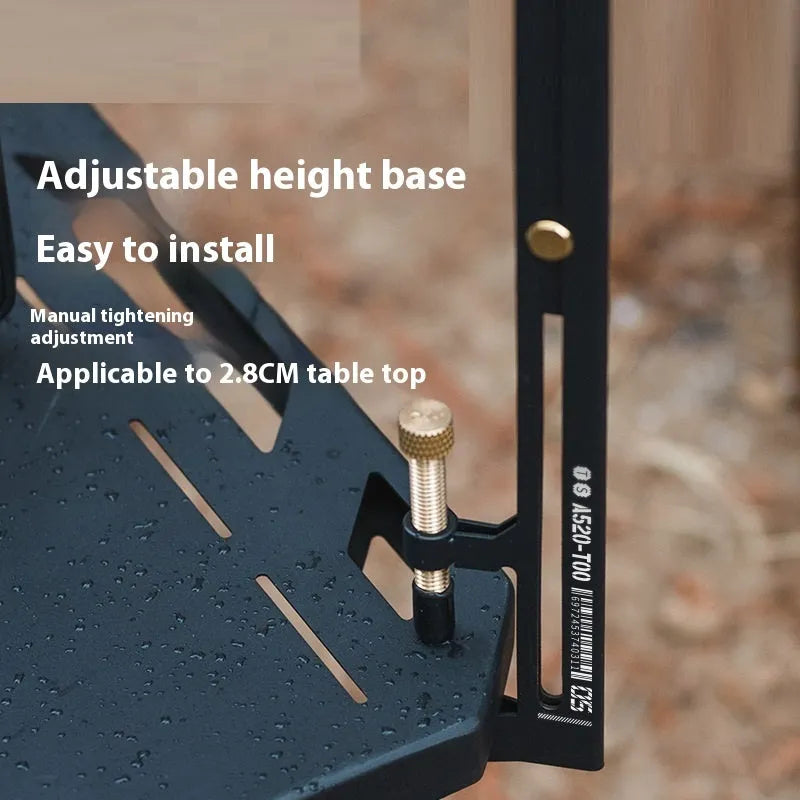 Black stainless steel telescopic lamp holder with gear adjustment mechanism on a desk edge.