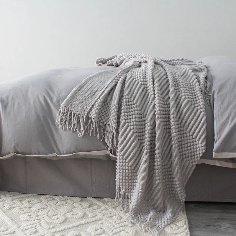 Small grey polyester nap blanket folded, showing its 127cm by 170cm size.