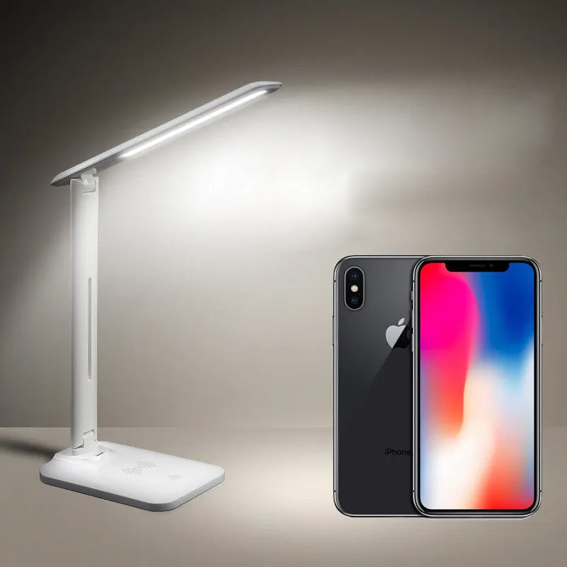 White eye protection desk lamp with wireless charging pad and touch dimmer on a desk