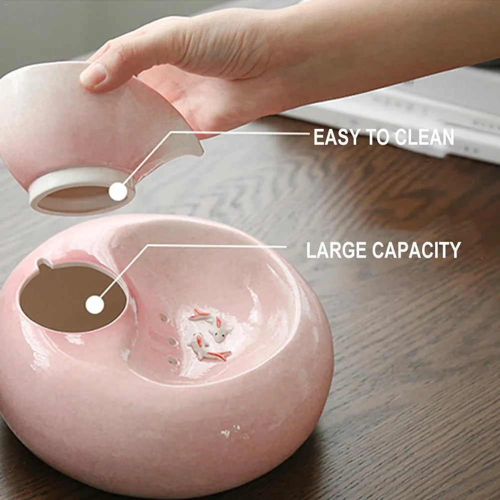 White ceramic automatic cat water dispenser with leaf design and US plug on a wooden floor