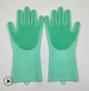 Blue silicone gloves with textured palm for scrubbing, shown on hands holding a pan.
