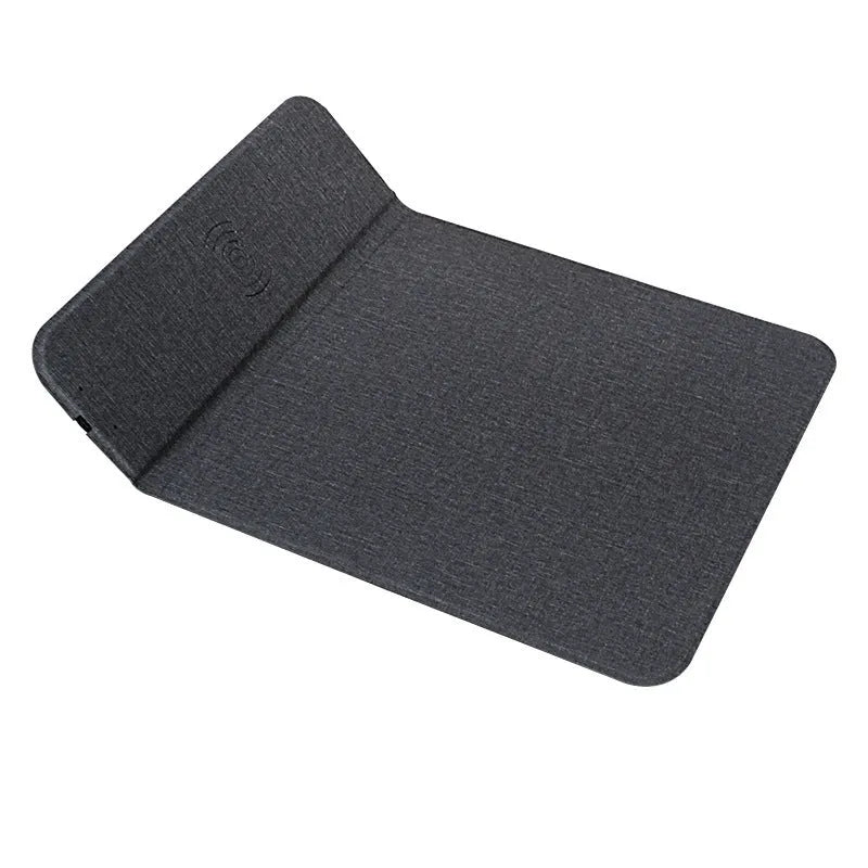 Fabric-covered foldable phone holder with wireless charging pad showing a smartphone placed on it.
