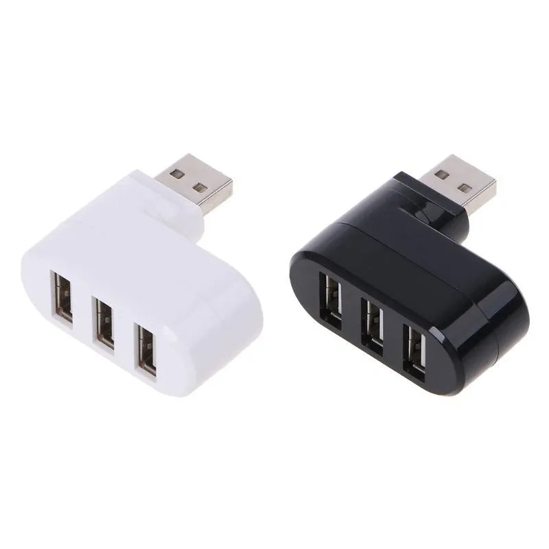 Black or white USB 2.0 four-port hub for laptop expansion on a desk.