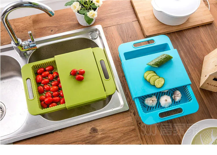 Blue kitchen chopping board with built-in sink drain basket and TPE handle on a counter.