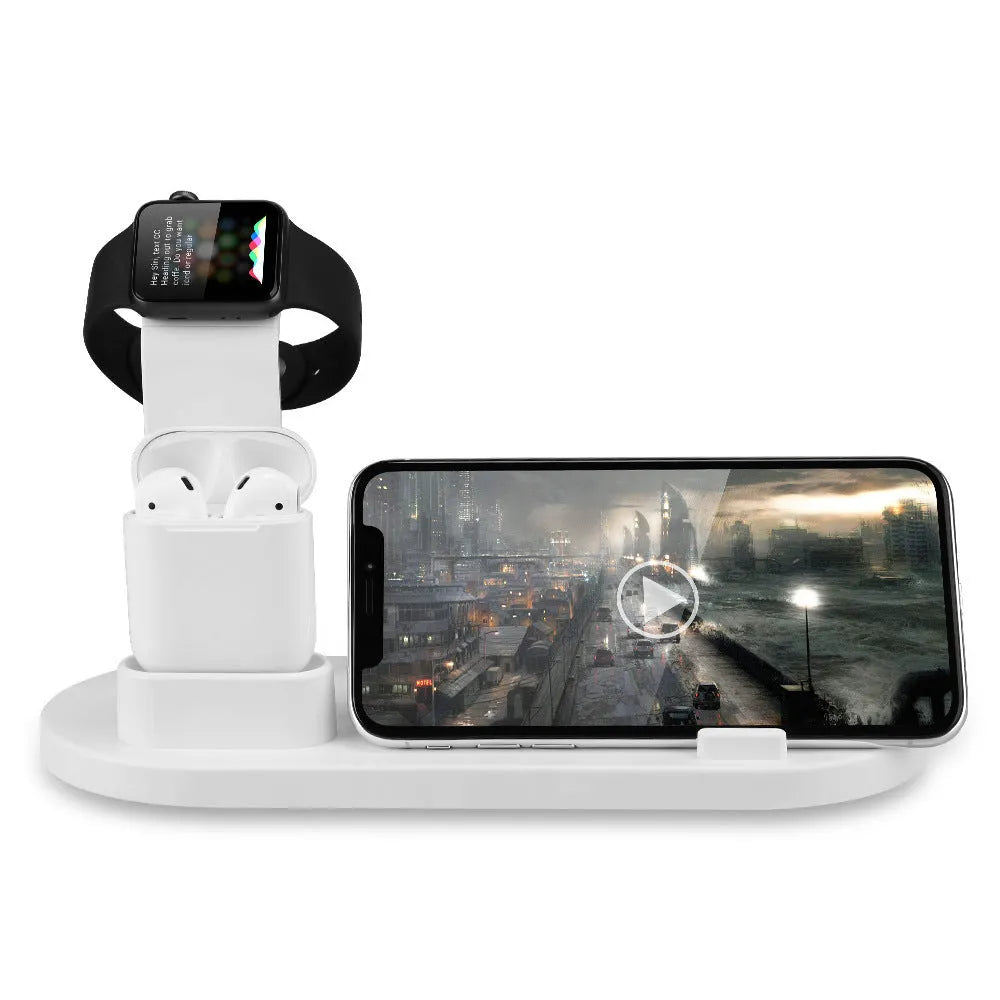White aluminium wireless charging stand holding phone, headphones and smartwatch