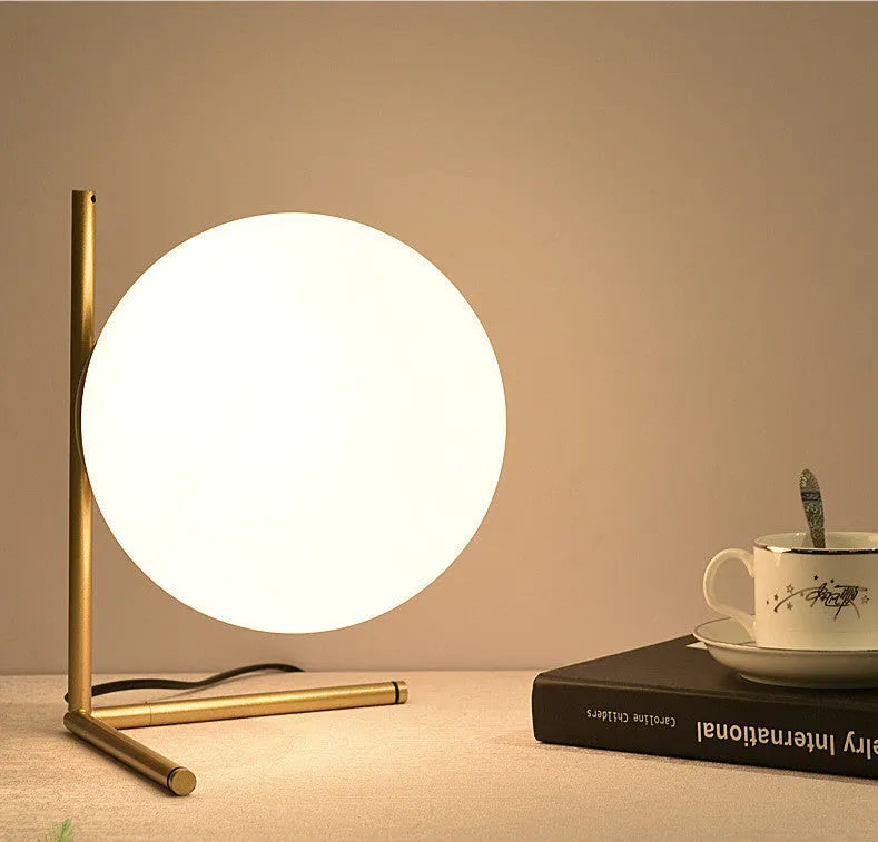 Glass shade LED desk lamp showing three size options and three-tone light colours on a desk.