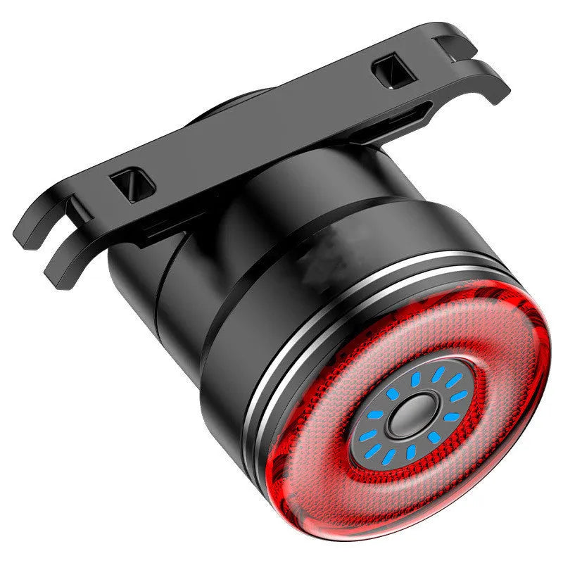Black aluminium alloy smart bicycle tail light showing USB port and brake-sensing sensor.