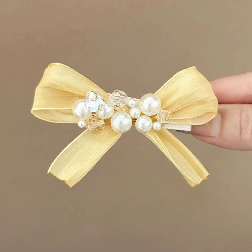 Yellow fabric bow barrette with rhinestone pearls on duckbill hair clip