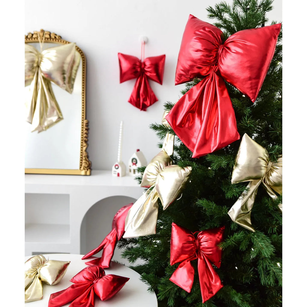 Christmas decorative bowknot with bright leather finish in red colour on a tree branch