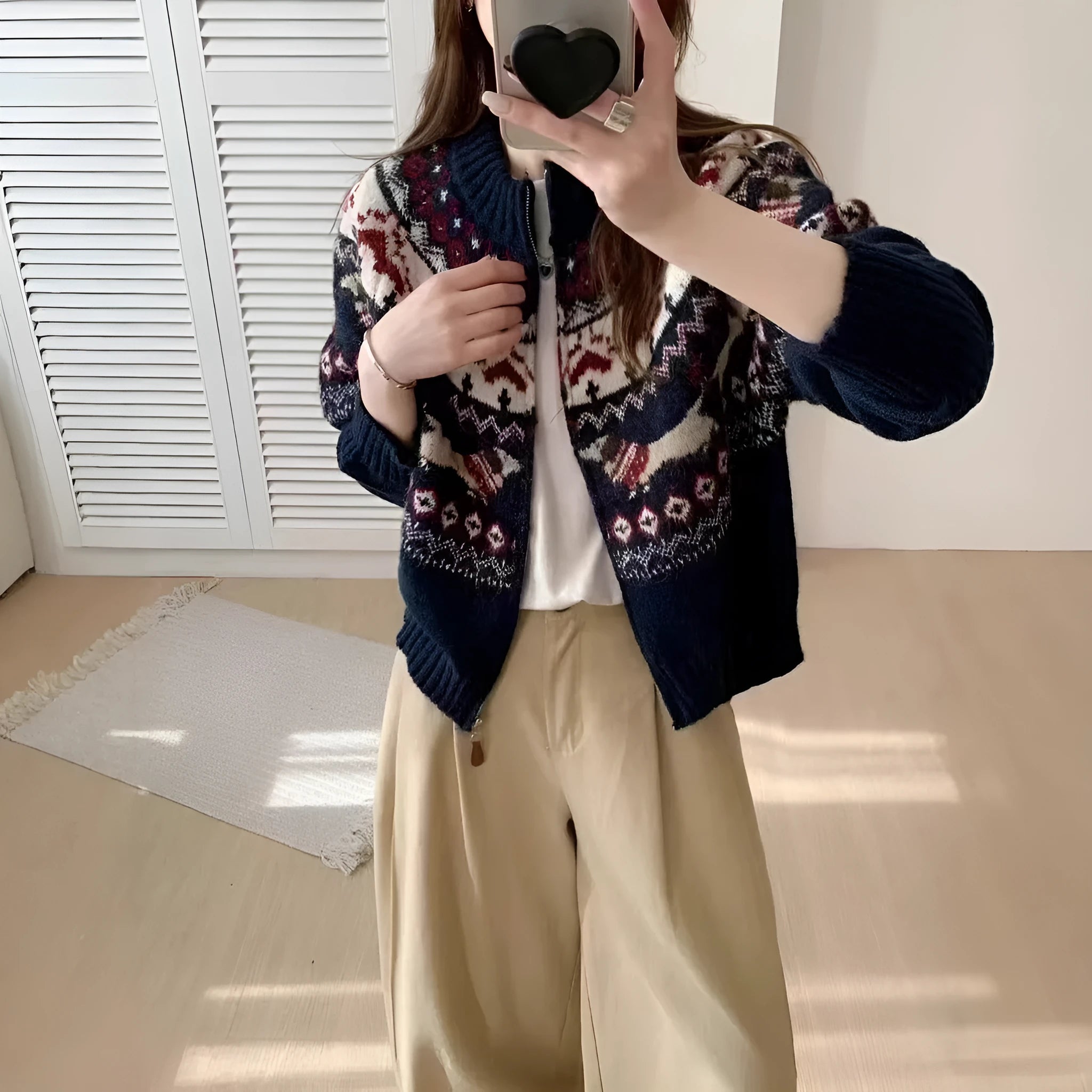 Ethnic patterned heavy industry jacquard pullover sweater in apricot colour, showing 3D texture and loose fit.