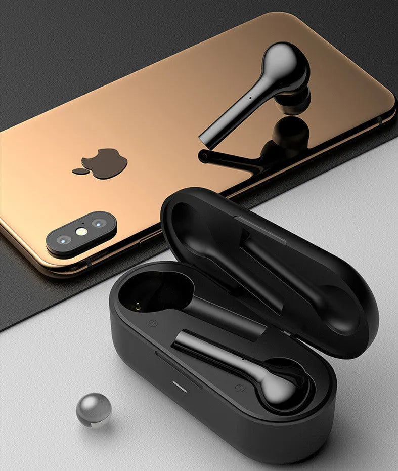 Black and white wireless touch control earbuds with a charging case on a table.