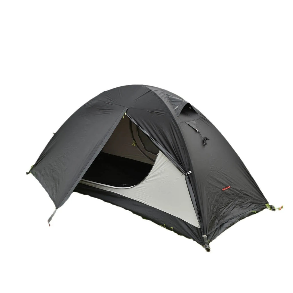 Single-person hiking tent in red pitched outdoors, showing aluminium poles and double-wall design with mesh inner.