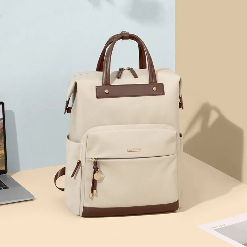 Women's large fabric backpack with synthetic leather trim in apricot colour, showing adjustable straps.