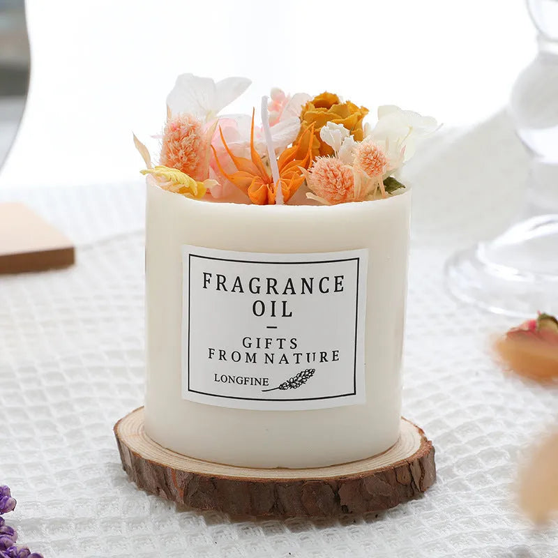 Decorative dried flower candle in jar with wooden chip base, available in nine botanical scents