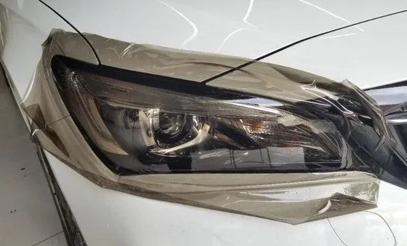 A roll of 30cm wide dark grey car lamp protective film for headlight and taillight protection.