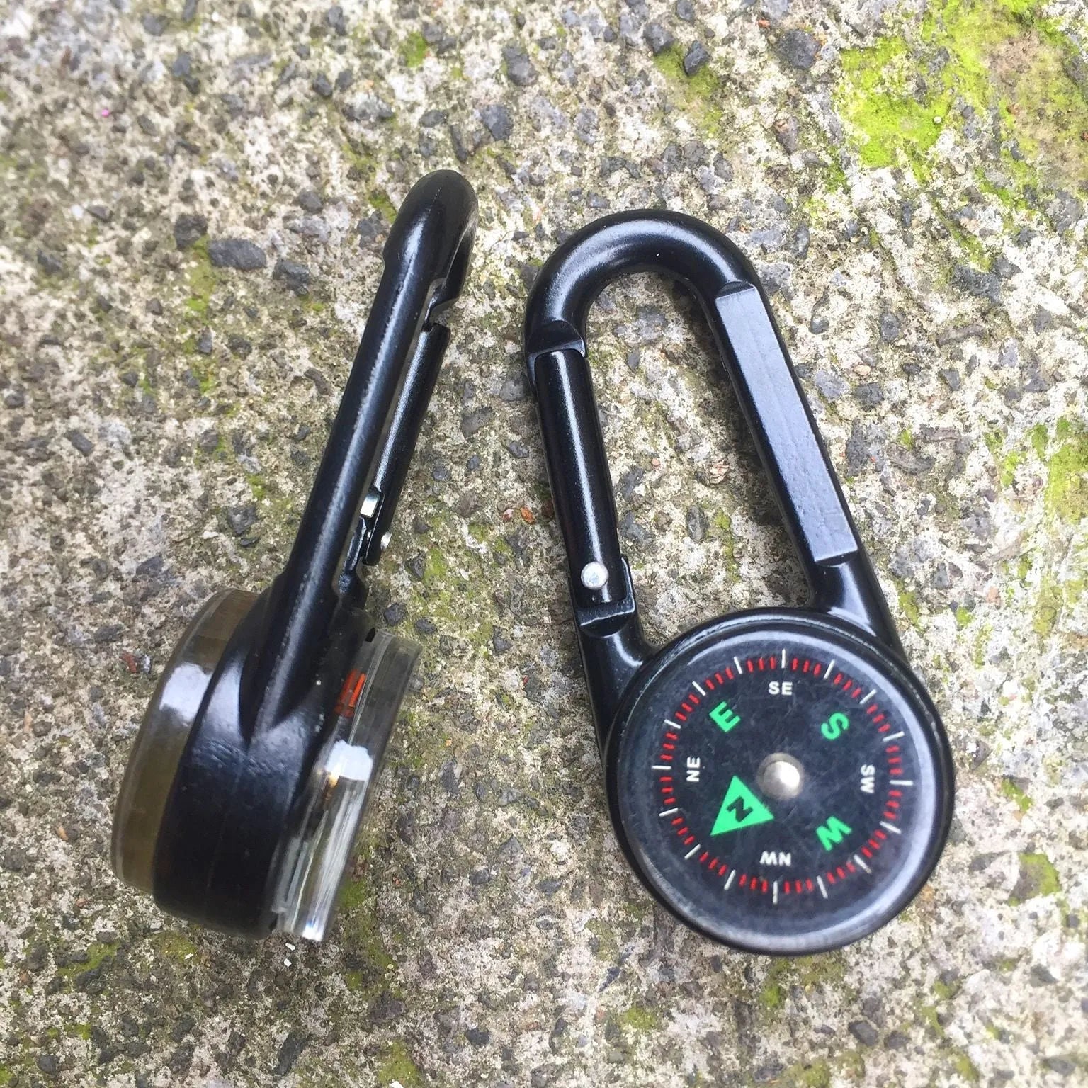 Black zinc alloy double-sided carabiner with a climbing button closure, showing integrated compass and thermometer.