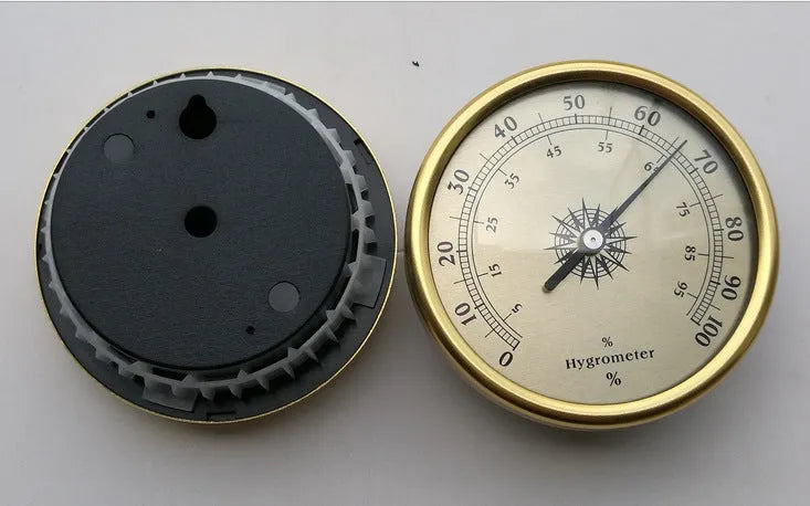 Analogue thermometer and hygrometer with silver aluminium dial and outer ring.
