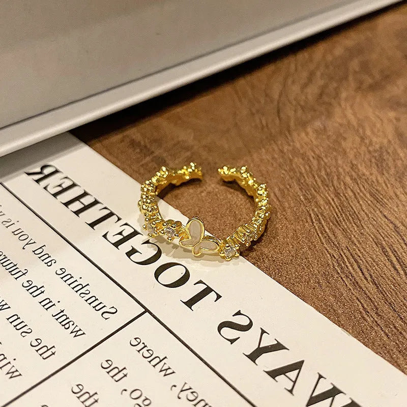 Copper butterfly women's ring with dripping oil texture and an open loop design.