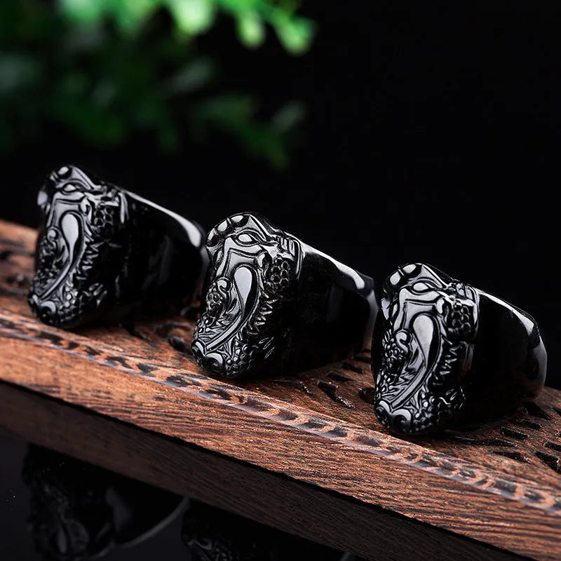 Men's obsidian Pixiu thumb ring showing natural gold sheen crystal on alloy band