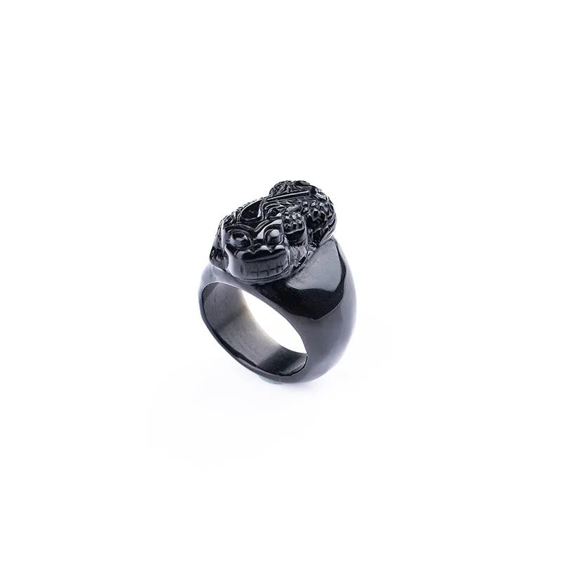Men's obsidian Pixiu thumb ring showing natural gold sheen crystal on alloy band