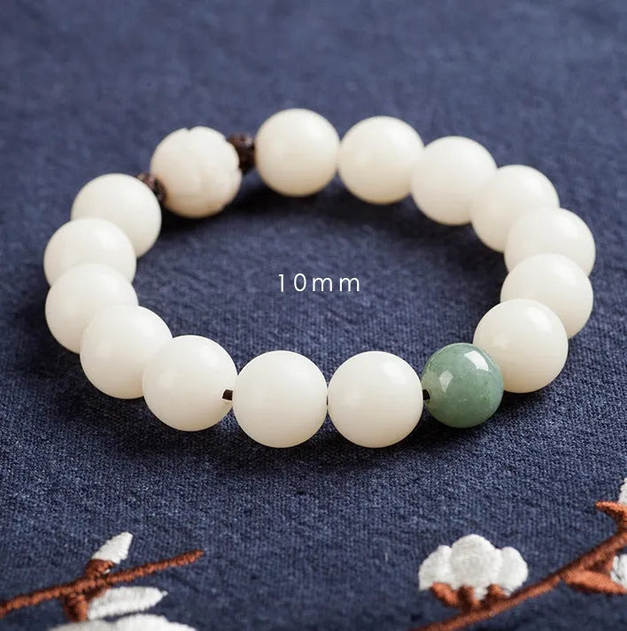 Natural white jade Bodhi bracelet with round beads and transfer bead on white background