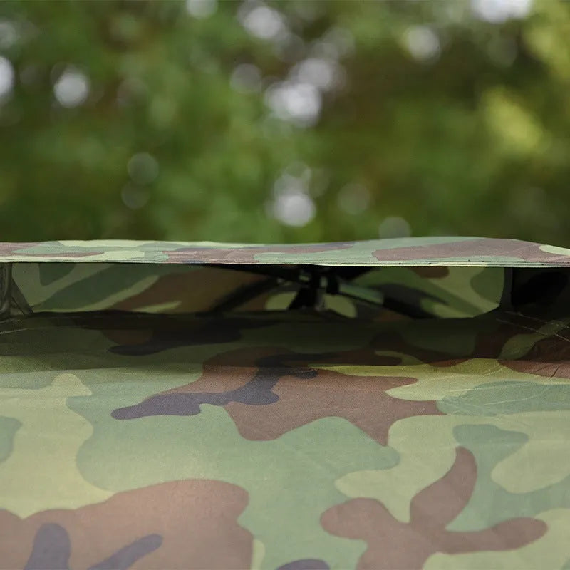Green camouflage tent with steel ground nails and breathable mesh sections for outdoor camping